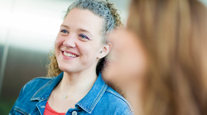 Young professional woman in the office smiling.