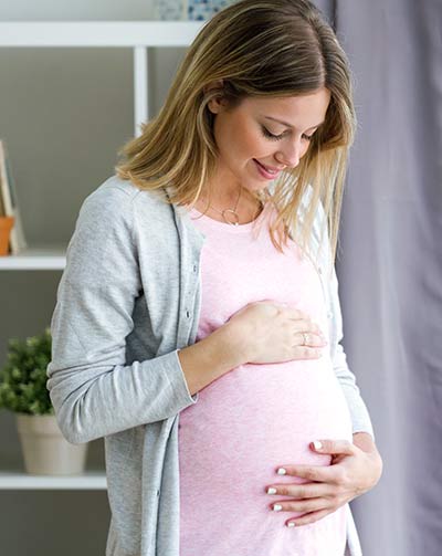 Beautiful pregnant woman relaxing at home