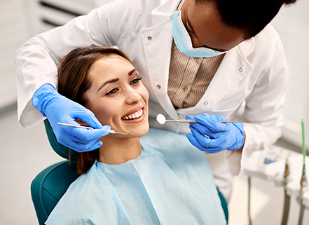 Young professional getting a routine teeth cleaning.