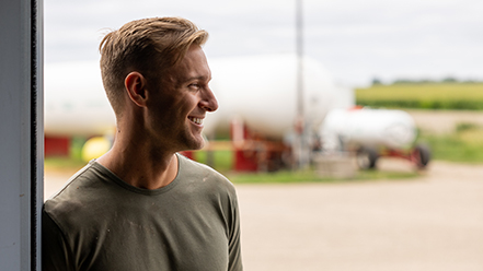 Young professional on farm smiling.