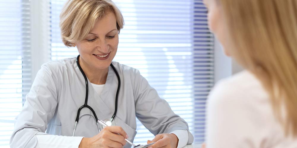 A woman visiting with a doctor