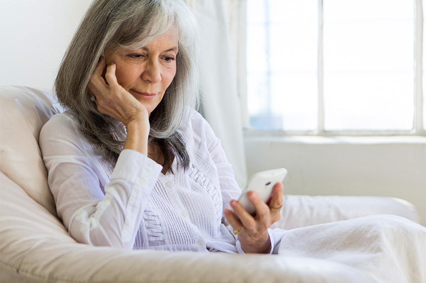 Medicare aged woman looking at a smart phone