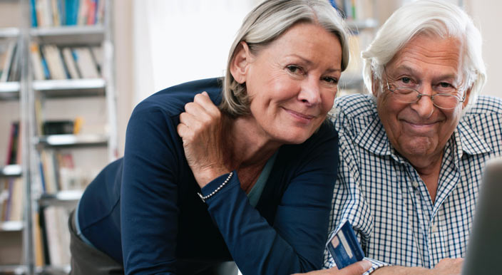 Medicare aged couple using a laptop