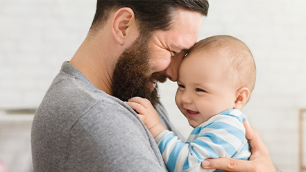 Father holding newborn. 