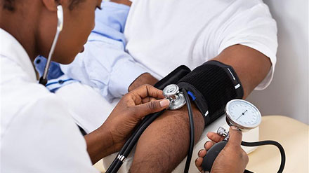 Patient getting blood pressure checked at clinic