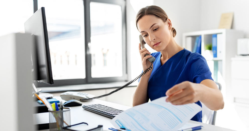 medical professional at office looking through papers