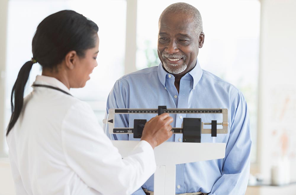 Man standing on a scale at doctor's office