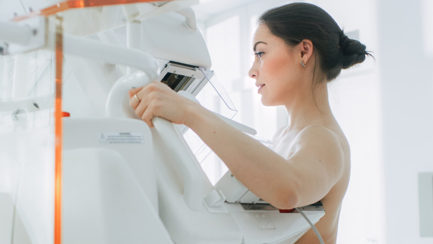 Female patient undergoing Mammogram screening procedure.