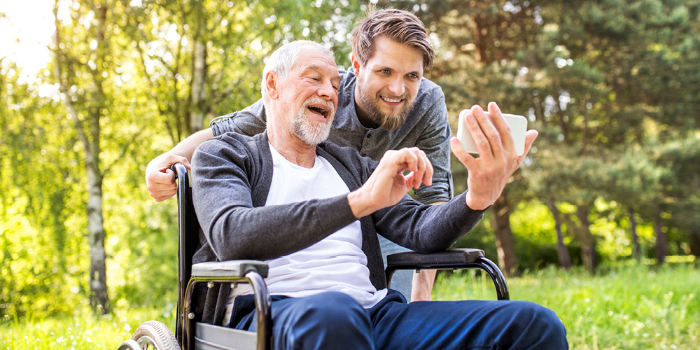 man in wheelchair and caregiver