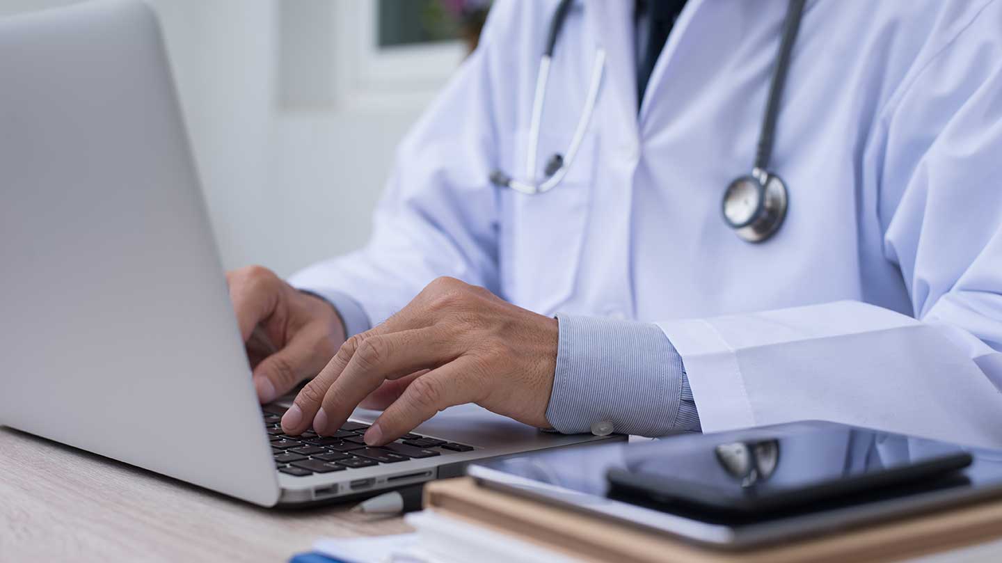 Doctor working on laptop computer