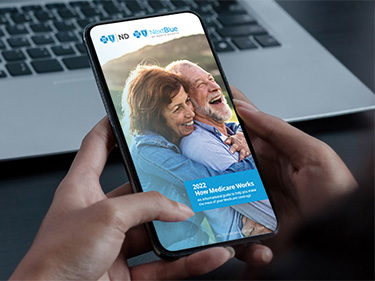 Individual reading medicare guide on phone.