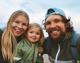 A smiling family outdoors