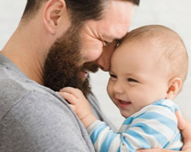 Bearded man holding a baby
