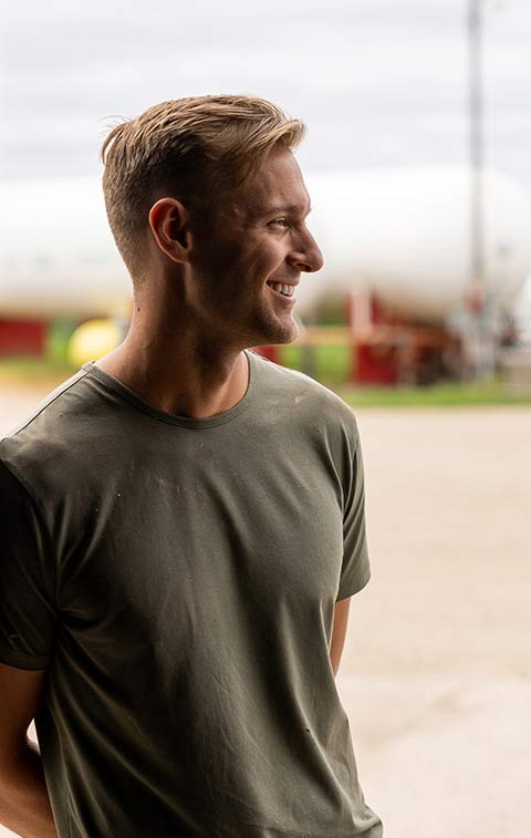 Young professional on farm smiling.