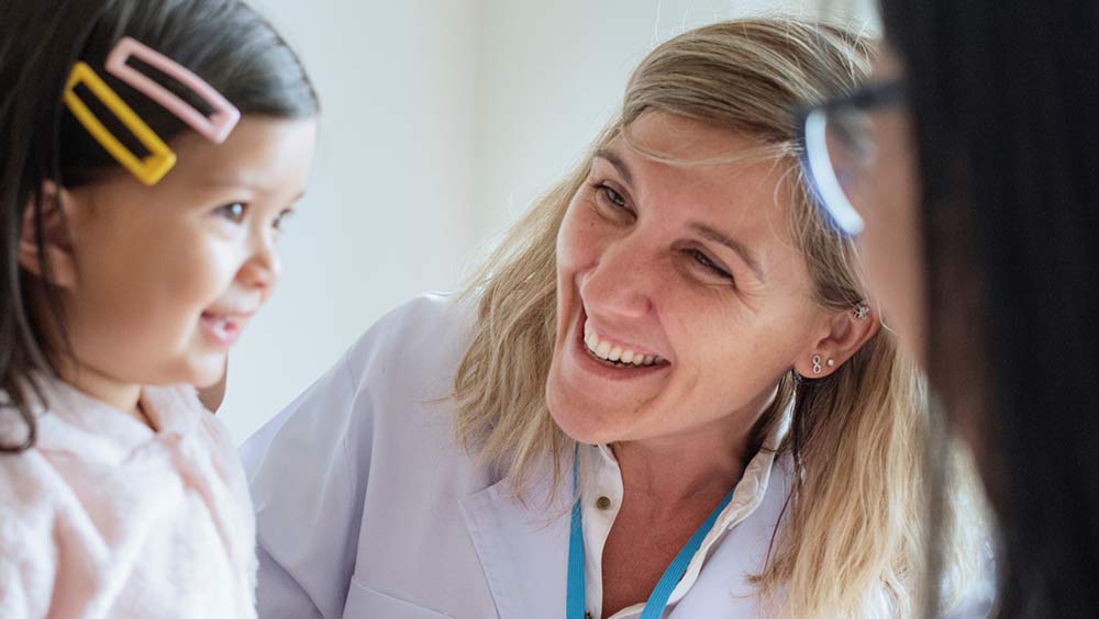 Pediatrician examining a little girl