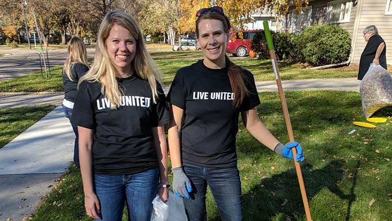 West Acres Development team volunteering raking leaves