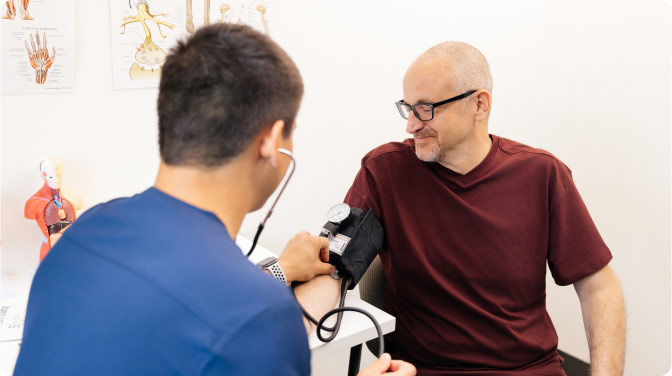 Man getting blood pressure checked in doctor's office