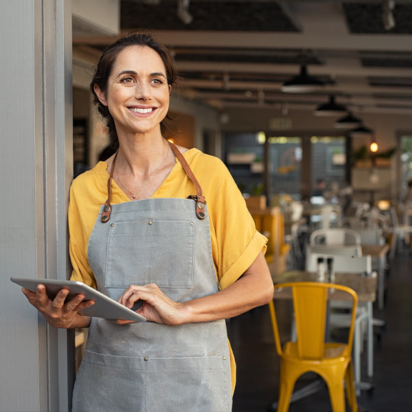 Female barista in apron working at a cafe