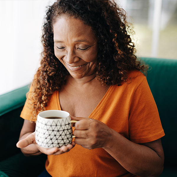 Medicare aged woman drinking coffee