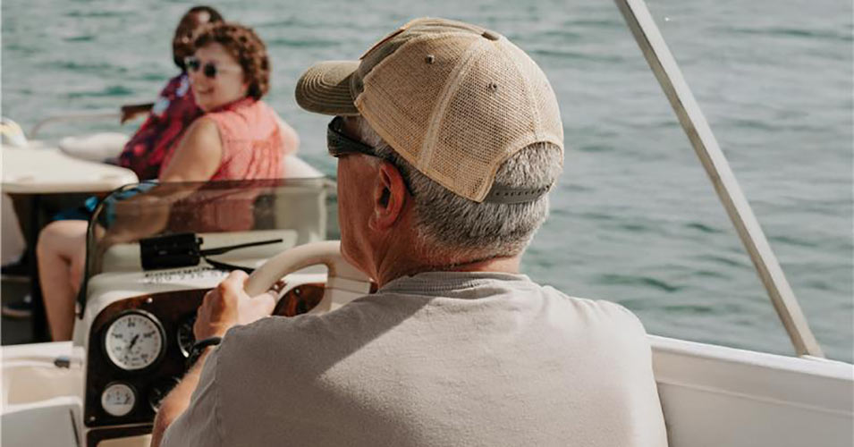 Retired man driving a boat