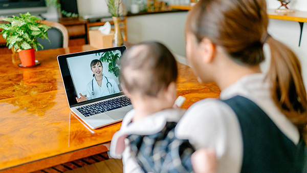 Mother and child watching video about medicine or having online consultation with doctor