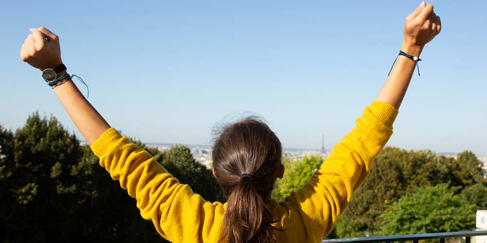 woman holding hands in the air celebrating