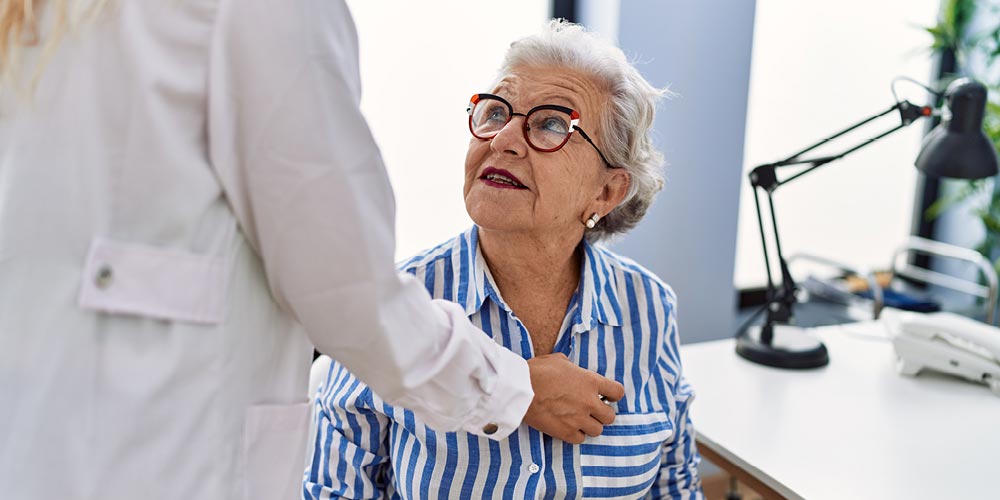 Patient having her heart examined by physician