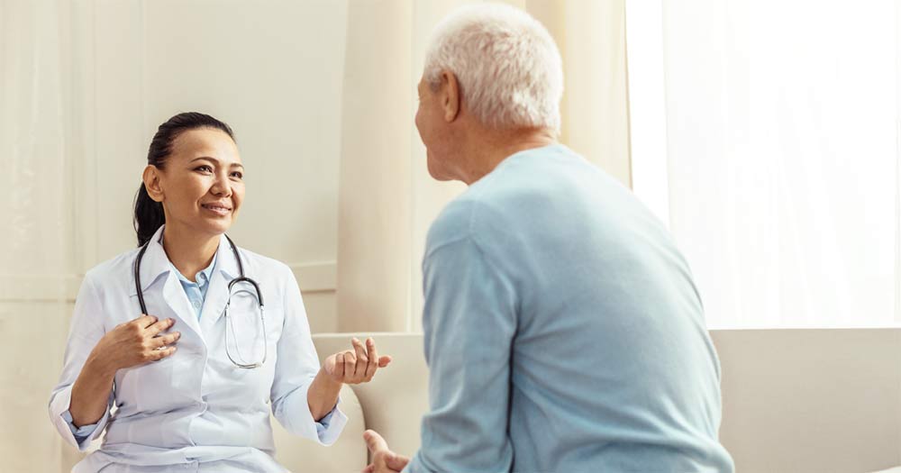 Senior man consulting with a female physician
