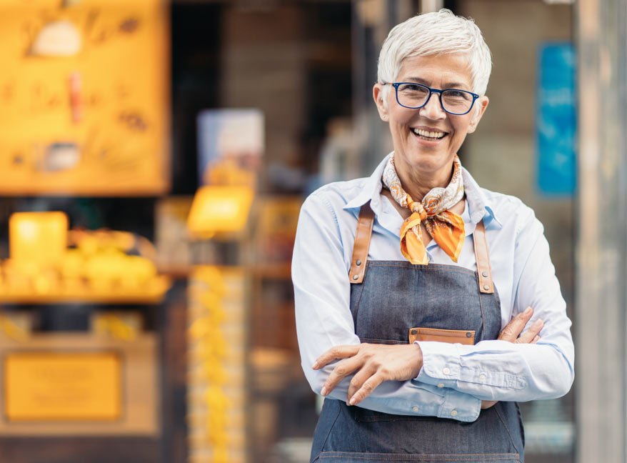 medicare aged woman wearing in apron working in a shop