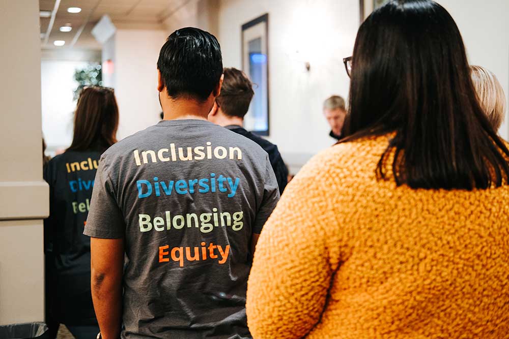 People wearing T-shirts that say Inclusion Diversity Belonging Equity