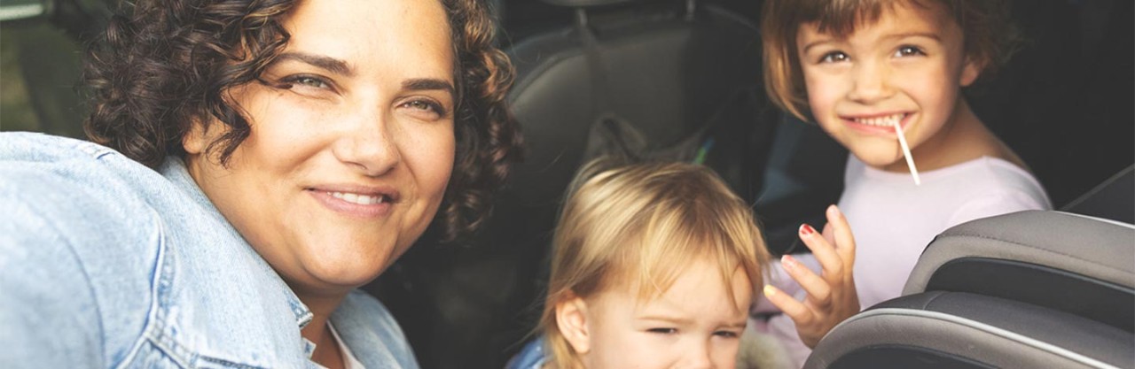 Smiling mom with two young kids