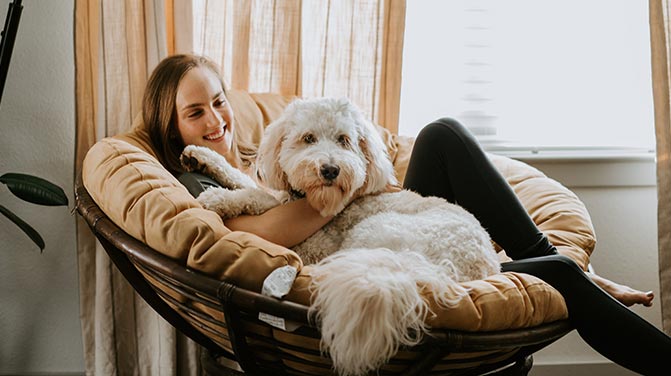 Woman sitting in a chair with her dog