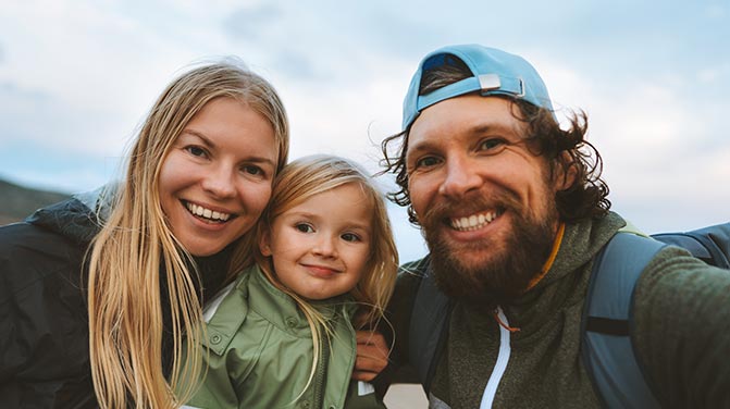 A smiling family outdoors