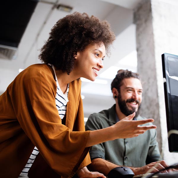 Coworkers looking at a computer screen together