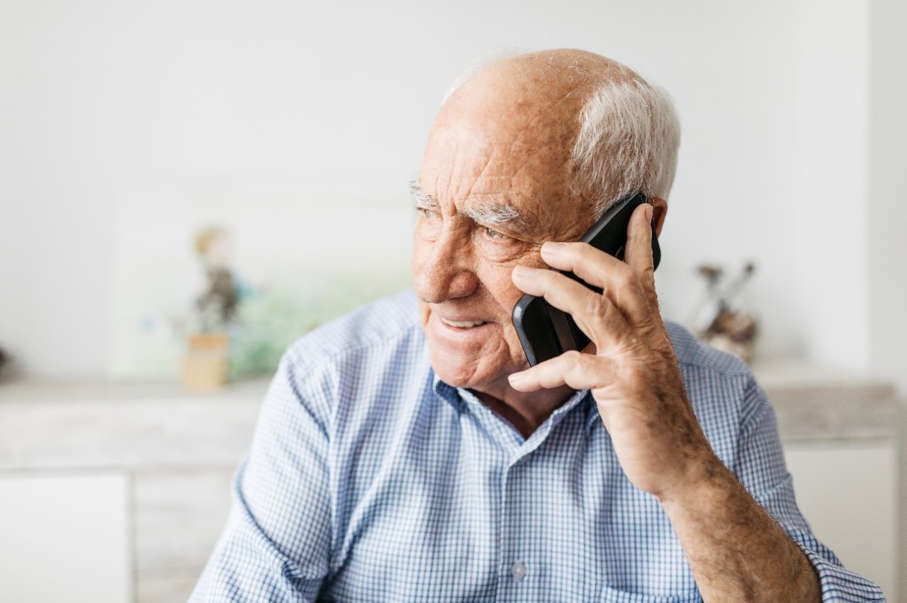 Man on phone using Learn to Live mental health therapy.