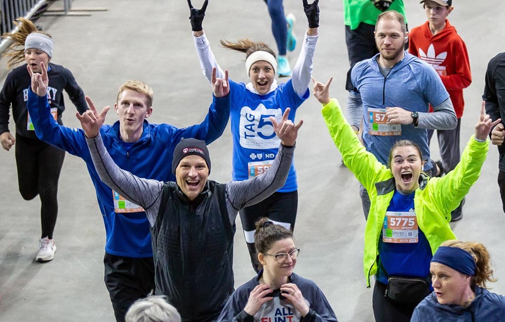 BCBSND President and CEO Dan Conrad and BCBSND employees running in the Fargo 5K.