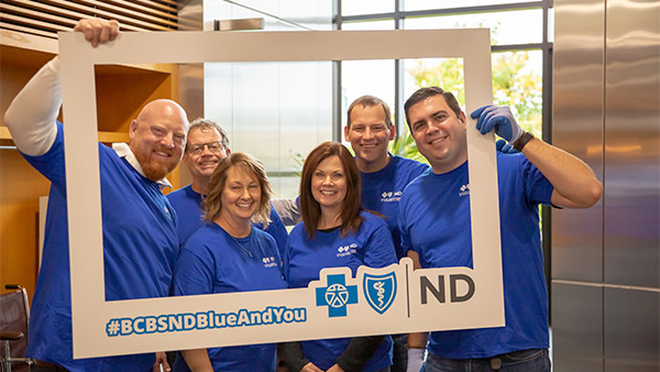 Employee volunteers smiling for a selfie