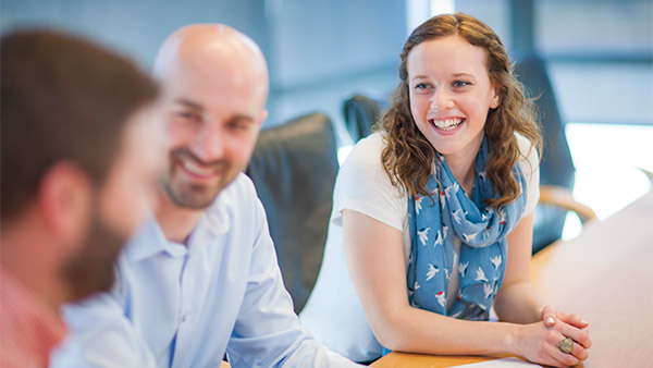 Employees visiting in a conference room