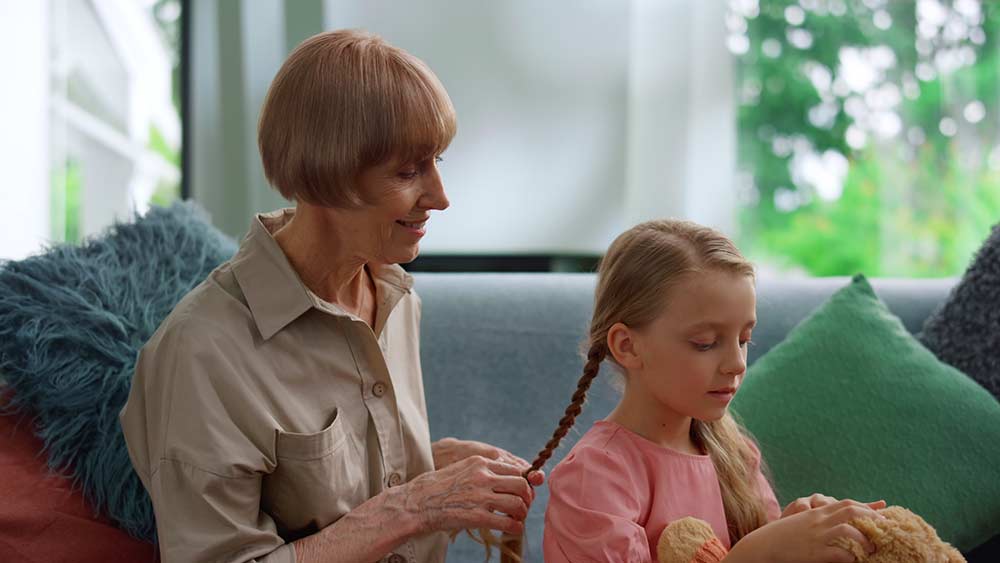Grandmother braiding a girl's hair