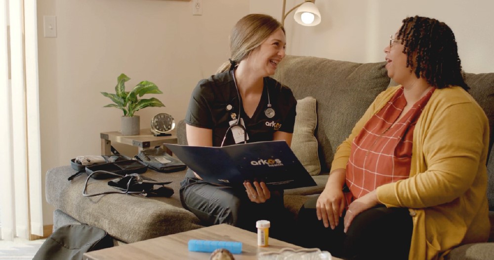 Mobile Outreach Services nurse talking with a patient during an in-home visit.
