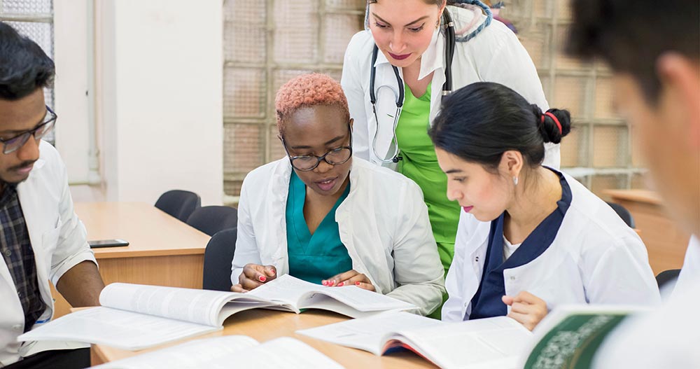 Medical students reading textbooks together