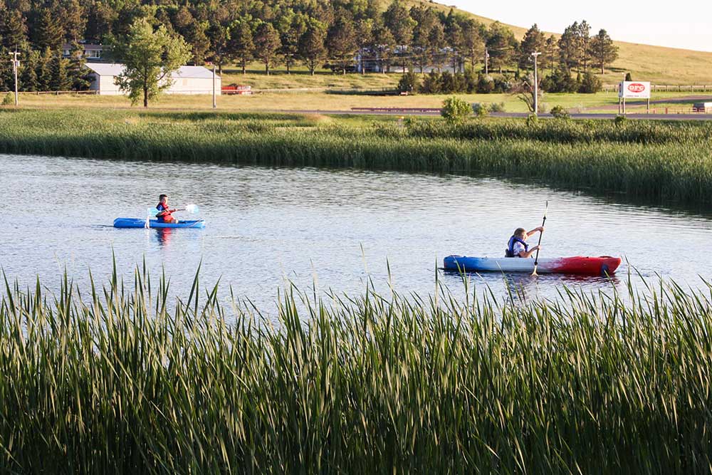 Rural community members using kayaks for rent from the Adams County Library.