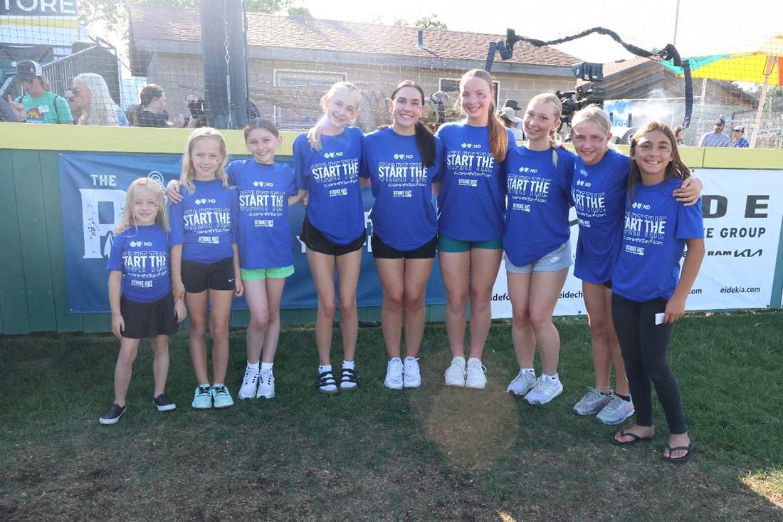 Children at a baseball game wearing Stirke Out the Stigma t-shirts