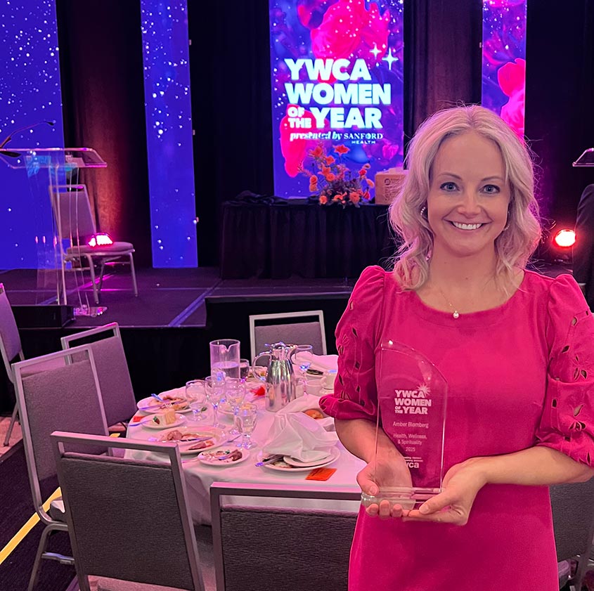 BCBSND employee Amber Blomberg with YWCA women of the year award