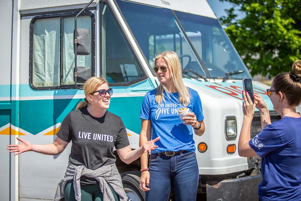 women wearing united way t-shirts at a food truck event