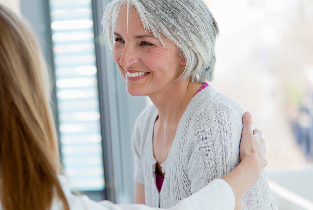 woman patting another woman on the back