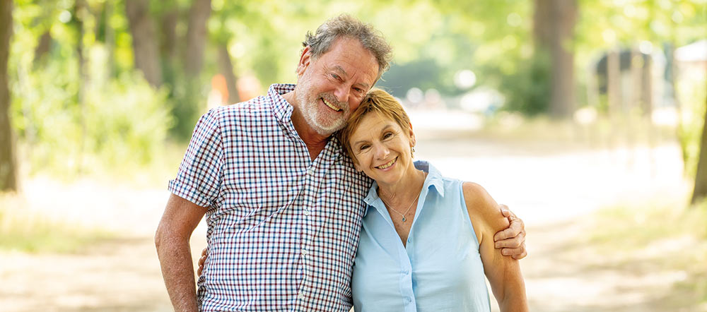 Happy senior couple walking and enjoying life outdoors