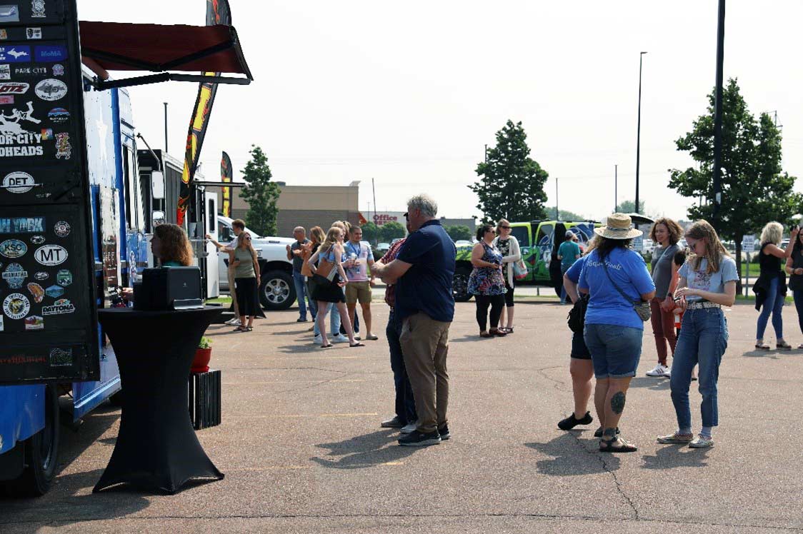 Community members waiting in line at a food truck