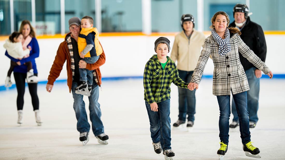 People ice skating at an indoor rink