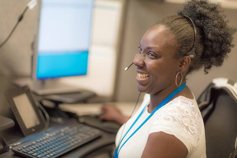 A smiling BCBSND customer advocate